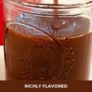 Caramel sauce being poured into a mason jar.